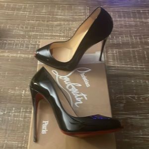 Christian Louboutin black patent peep toe pumps.